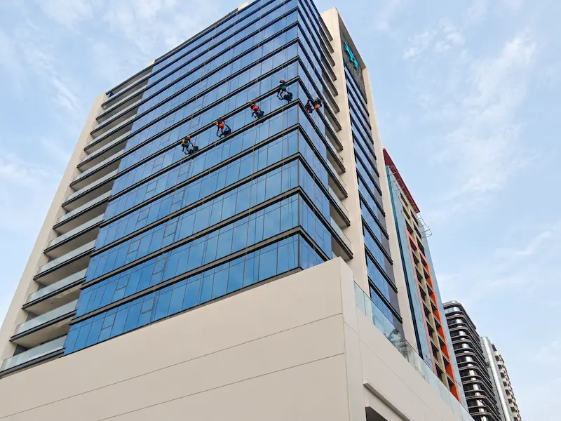 Glass facade cleaning for a commercial building in Dubai
